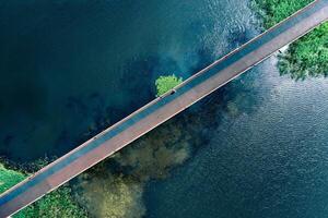 Drone top view lake and footbridge with sports running rubber coating photo