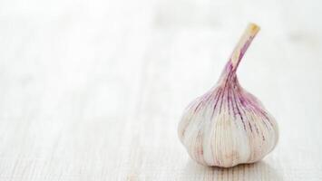 Garlic bulb on white wooden background photo