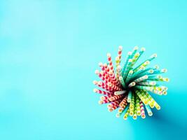 colorful paper drinking straws on blue background photo