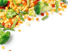 Frozen vegetables assorted isolated on white with clipping path. Frosen vegetables with ice Isolated one edge. Frozen mix vegetables with copy space for text. Top view or flat-lay. photo