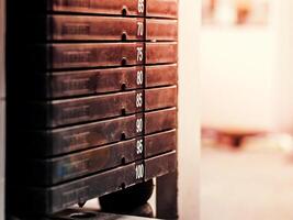 Stack of rusty metal weights in gym bodybuilding equipment photo