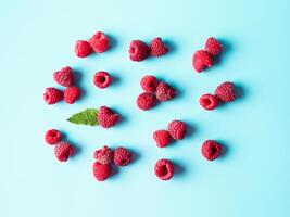 Raspberry pattern, blue background, top view photo