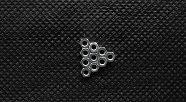 Triangle Media Play Symbol From Nuts On Black Perforated Surface photo