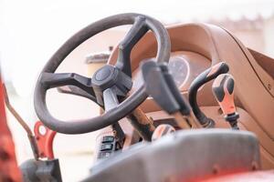 Tractor steering wheel and control panel close-up photo