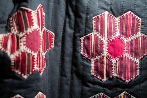 Quilt with red and pink hexagonal patchwork patterns photo
