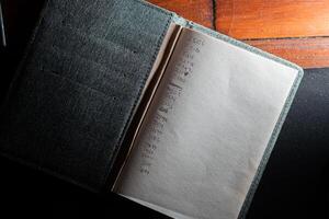 Open notebook with handwritten numbers on a wooden surface photo