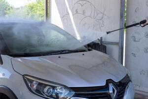 Grodno, Belarus - 06.01.2020 Washing a silver Renault Kaptur or Captur car on the first day of summer photo