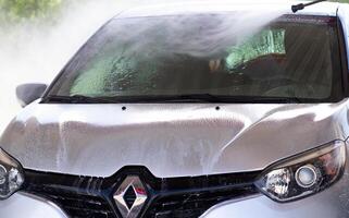 Grodno, Belarus - 06.01.2020 Washing a silver Renault Kaptur or Captur car on the first day of summer photo