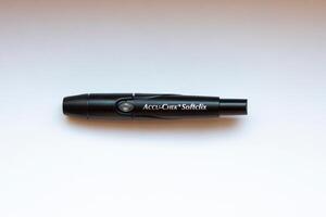 Poznan, Poland - 10.20.2022 Accu-Chek Softclix finger piercing device on an isolated background photo