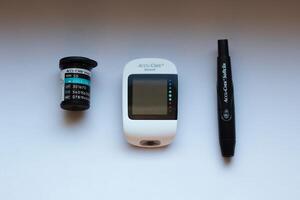 Poznan, Poland - 10.20.2022 Accu-Chek Instant glucose meter with test strips and finger piercing device photo