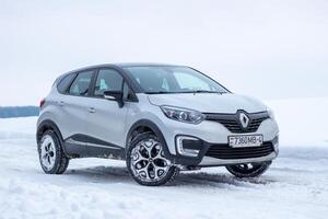 Grodno, Belarus-01.31.2021 Renault Kaptur or Renault Captur SUV on a winter road against the background of a field and forest. Winter driving conditions in Renault on a snowy road photo