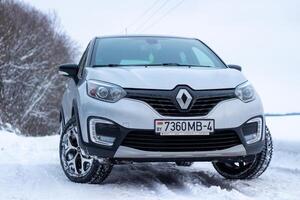 Grodno, Belarus-01.31.2021 Renault Kaptur or Renault Captur SUV on a winter road against the background of a field and forest. Winter driving conditions in Renault on a snowy road photo
