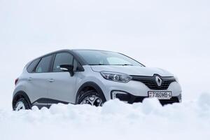 Grodno, Belarus-01.31.2021 Renault Kaptur or Renault Captur SUV on a winter road against the background of a field and forest. Winter driving conditions in Renault on a snowy road photo