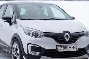 Grodno, Belarus-01.31.2021 Renault Kaptur or Renault Captur SUV on a winter road against the background of a field and forest. Winter driving conditions in Renault on a snowy road photo
