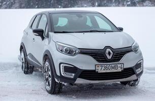 Grodno, Belarus-01.31.2021 Renault Kaptur or Renault Captur SUV on a winter road against the background of a field and forest. Winter driving conditions in Renault on a snowy road photo