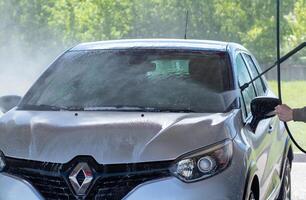 Grodno, Belarus - 06.01.2020 Washing a silver Renault Kaptur or Captur car on the first day of summer photo