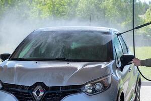 Grodno, Belarus - 06.01.2020 Washing a silver Renault Kaptur or Captur car on the first day of summer photo