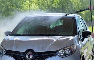 Grodno, Belarus - 06.01.2020 Washing a silver Renault Kaptur or Captur car on the first day of summer photo