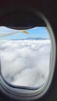 Scenic View from an Airplane Window Above the Clouds with Beautiful Blue Sky Below video
