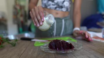 A cutting board with fresh beetroot, surrounded by ingredients for a recipe preparation video