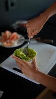 In a vibrant kitchen, hands skillfully prepare avocado guacamole for a classy dining experience video