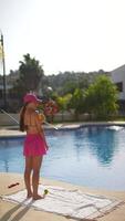 Mother and Child Relaxing by Poolside With Beautiful Landscape and Palm Trees under Sunny Sky video