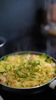 Preparing appetizing Fettucine Pasta with Vegetables in a frying pan on the Stove video