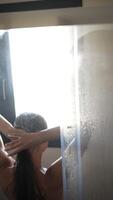 Experience a refreshing morning shower routine with sunlight streaming through the window video