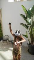 Woman is immersed in an immersive virtual reality experience wearing a VR headset video