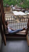 Finding peace and relaxation indoors, dressed comfortably, while peering out the window video