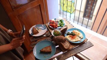 Delicious Breakfast Spread with Omelette, Fruits, and Avocado Toast on Rustic Table video