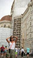 A tourist is delighted by the stunning architecture of Florence on a sunny summer day video