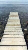 A peaceful wooden dock over calm waters, offering serenity and relaxation, a picturesque getaway video