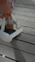 A child in a floral skirt wears a VR headset, enjoying the modern tech and sunny weather video