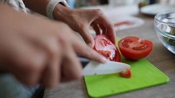 Slicing Fresh Tomatoes with a Sharp Ceramic Knife on a Vibrant Green Cutting Board video