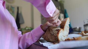 Breaking bread by hand in a welcoming kitchen setting, creating a cozy and comforting atmosphere video