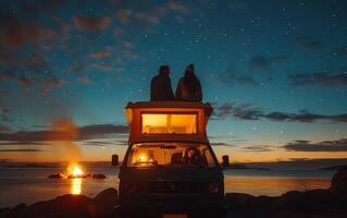 Couple Sitting on Top of Camper Van at Sunset photo