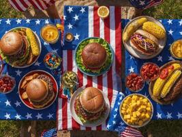 People having typical american picnic food on table with us flag photo