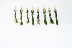 Handmade smudge sticks hanging from rope to dry. photo