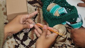 Female hands close-up. Handmade. Colored yarn and knitting needles. photo
