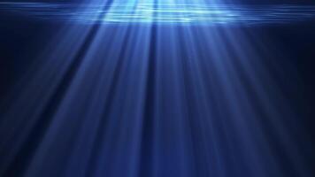 Underwater rays of light in the dark ocean sea. Beautiful waves and sun rays of light are visible from the depths. Mysterious underwater landscapes video