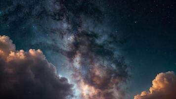 A night time sky with stars and the milky way behind some dramatic clouds. photo