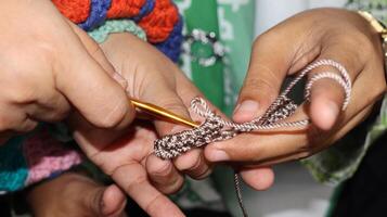 Female hands close-up. Handmade. Colored yarn and knitting needles. photo