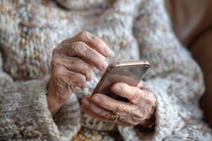 Elderly woman using a smartphone in a cozy sweater, focusing on the screen photo