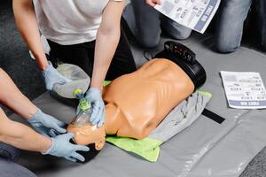 First Aid Training - Cardiopulmonary resuscitation. First aid course on cpr dummy. photo