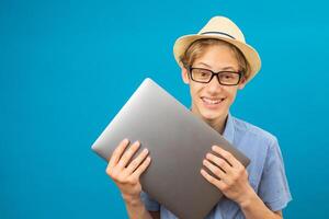 Waist up happy portrait view of the funny businessman teen holding laptop in hands. photo