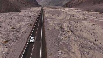 Highway in desert valley with mountains offers scenic landscape for adventurous journey video