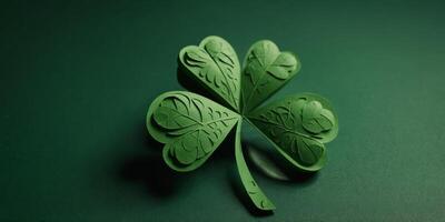 St Patricks day four leaf clover paper cut on green background. photo