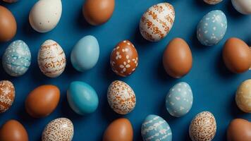 Frame of Easter eggs on a blue background Top view, vertical. photo