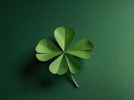 Paper art four-leaf clover made of small four-leaf clovers on green background. photo